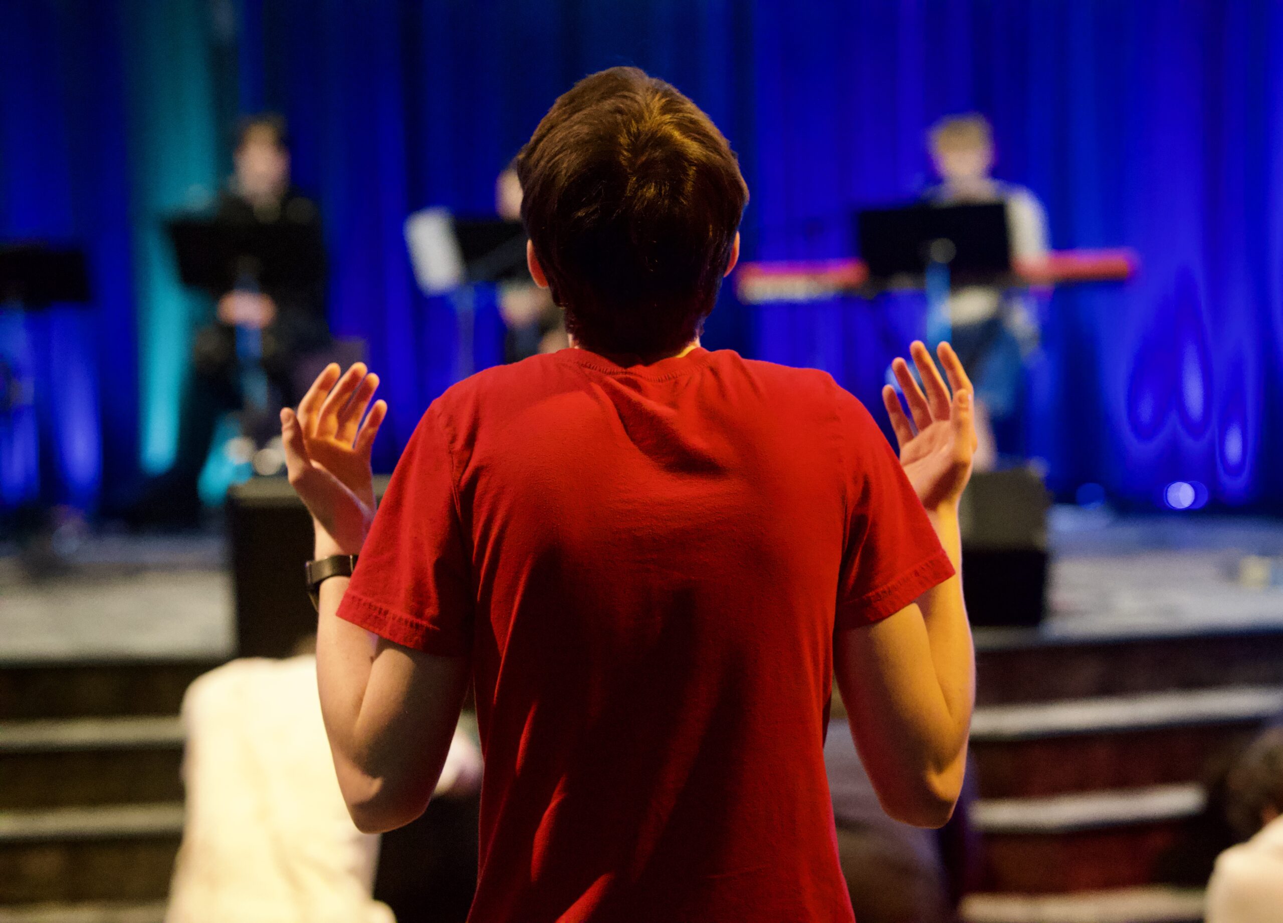 Student worshipping at Revolution Youth