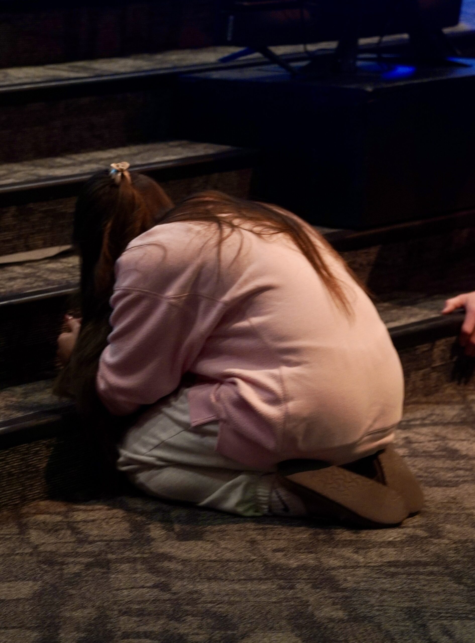 Student praying at Revolution Youth